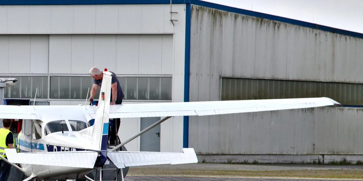 Ground crew refuelling the wing tank of a Cessna 172 at JadeWeserAirport, Germany